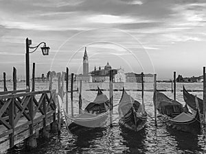 Blurred gondolas at San Marco with view in early morning to island San Georgio Maggiore in Venice