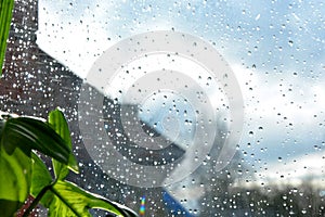 Blurred gray and blue background. Raindrops on the transparent window pane. Background of raindrops.