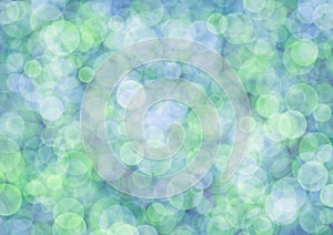 Blurred green background with light olive and blue circle sparkling lights