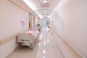 Blurred hospital indoor corridor hallway with beds as background for graphic pursuit