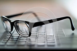 Glasses on the computer keyboard