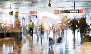Blurred image of airline Passengers in an International Airport inside a busy terminal