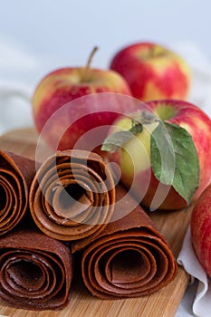 Blurred image of apples and pastilles on the plank