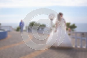 Blurred image background wedding theme on the beach, embankment young couple