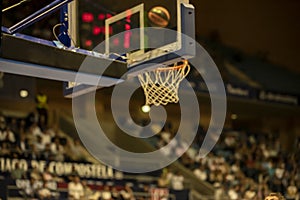 blurred image of a basketball approaching the hoop