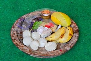 Blurred image, Bengali sweets, banana , mango etc. materials to be offered for worshipping lord Jagannath is arranged and placed