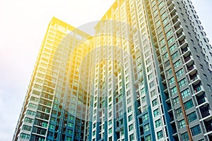 Blurred image of building with sky and sun flare