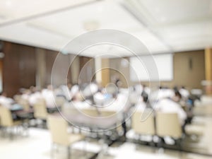 Blurred image of education people and business people sitting in conference room for profession seminar and the speaker is present