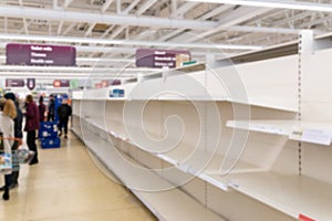 Blurred image of empty supermarket shelves due to Coronavirus induced stockpiling