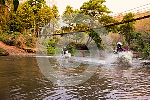 Blurred image enduro motorcycle racer drove into the water