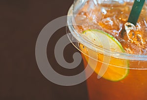 Blurred image glass of lemon iced tea. Close up on lemon