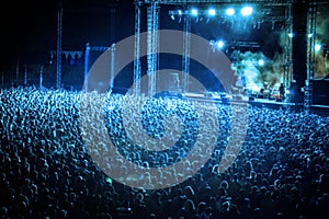 Blurred Image of Huge Crow of People at Music concert, in blue t photo