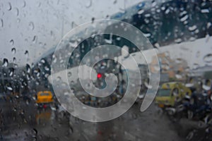 Blurred image, Image shot through raindrops falling on wet glass, abstract blurs of traffic - monsoon stock image of Kolkata