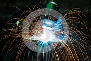 Blurred image of Industrial steel welder making sparks with grinder