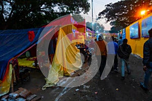 Blurred image, Kolkata, West Bengal, India. Devotees walking at Gangasagar transit camp to visit Hindu sadhus at their camps , photo
