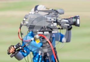 Blurred image of a man is recording VDO during golf tournament. photo