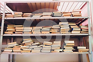 blurred Image many old books on bookshelf in library.