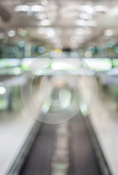 Blurred image of moving modern escalator way in the airport hall