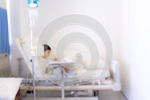 Blurred image of Patient with drip in hospital for background us