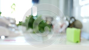 Blurred image of a person with protective gloves in hands cleaning kitchen countertop with dry wipes