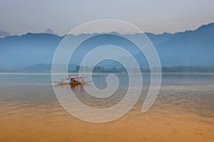 Blurred image, reflection of Himalayan mountains on Dal Lake, Srinagar, Jammu and Kashmir, India. Houseboats floating on the