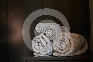 Blurred image,Rolls of clean white spa towels are folded next to the mattress to be ready for customers to use when it`s time to