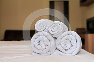 Blurred image,Rolls of clean white spa towels are folded next to the mattress to be ready for customers to use when it`s time to
