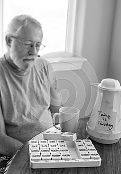 Blurred image of sad man with post it note on old coffee carafe