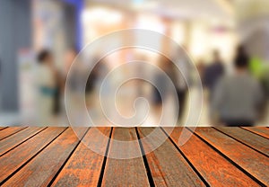 Blurred image wood table and abstract department store shopping