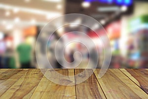 Blurred image wood table and abstract department store shopping