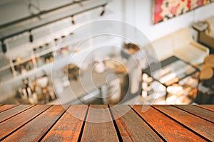 Blurred image wood table on people in cafe resaturant vintage c