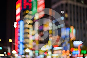 Blurred of bokeh light and renown night life around shinjuku neighborhood. Street illuminated at night photo