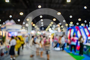 Blurred images of trade fairs in the big hall. image of people walking on a trade fair exhibition or expo where business people