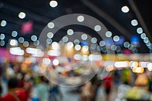 Blurred images of trade fairs in the big hall. image of people walking on a trade fair exhibition or expo where business people