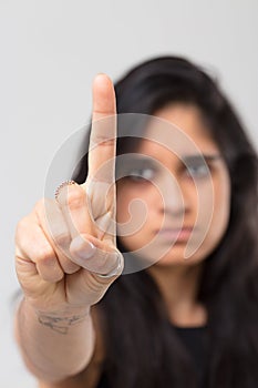 Blurred Indian girl warns denies with finger