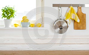 Blurred kitchen interior background with wooden table top in front