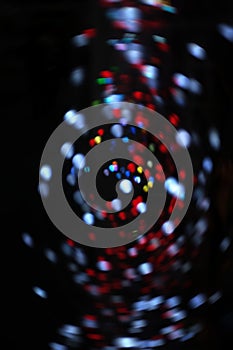 Blurred LED screen closeup. Glowing threads in a color spectrum on a black background