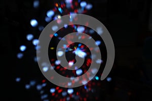 Blurred LED screen closeup. Glowing threads in a color spectrum on a black background