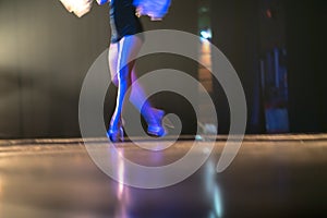 Blurred legs of ballet dancer on stage in theater