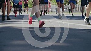 Blurred legs of people running marathon