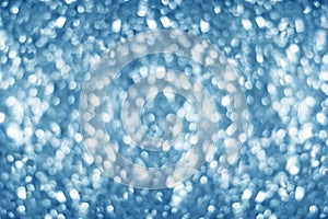 Blurred lifgt blue shiny glitter bokeh background, defocused soft blue silver shimmer backdrop design