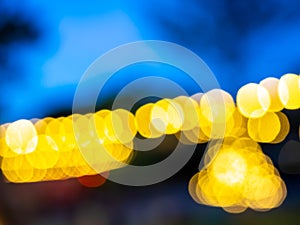 Blurred of light bulbs with twilight colorful sky in courtyard for background