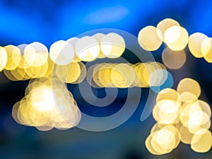 Blurred of light bulbs with twilight colorful sky in courtyard for background