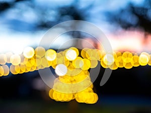 Blurred of light bulbs with twilight colorful sky in courtyard for background