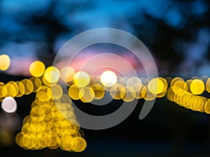 Blurred of light bulbs with twilight colorful sky in courtyard for background