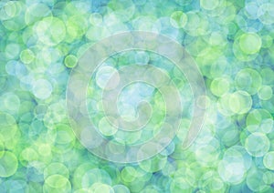 Blurred light green background with blue circle sparkling lights. Shiny olive glittery bokeh of christmas garland