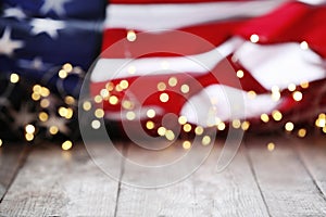 Blurred lights and American flag on wooden table