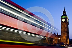 Blurred London double-decker bus passes Big Ben