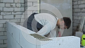 Blurred male builder working at construction site