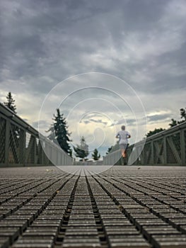 Blurred man running on a bridge
